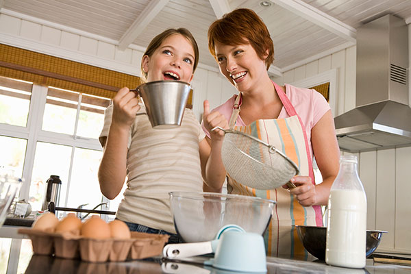 Mom and daughter baking together