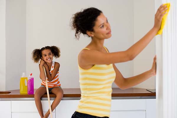 A mom and daughter cleaning the house