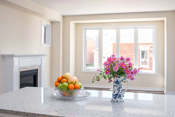 Beautiful kitchen counter with a bouquet of flowers and a bowl of fruit decor
