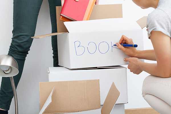 Boxes of books being packed by college students
