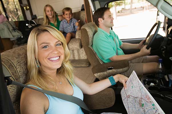 A family on vacation inside their RV driving.