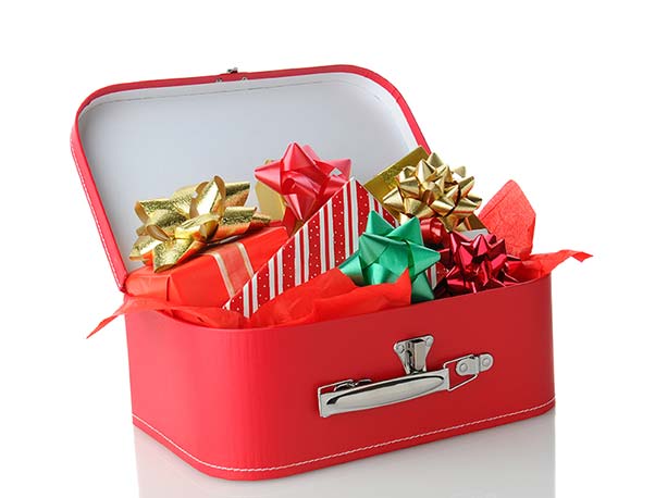 Many wrapped Christmas gifts hidden inside a suitcase.