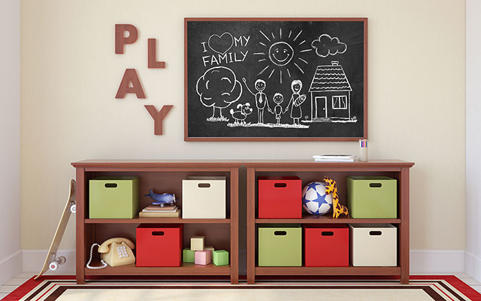 3D rendering of a child's playroom with colorful bins and shelves, toys, a chalkboard and the word "play" on the wall