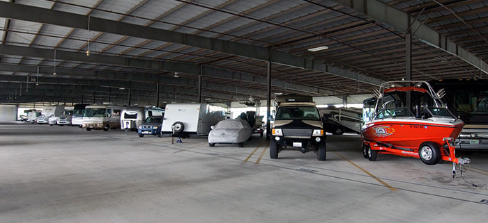 Cars, trucks, RV's, boats and trailers parked for storage at Price Self Storage 100,000 Sq Ft Indoor RV, Boat & Vehicle storage facility in Solana Beach, CA