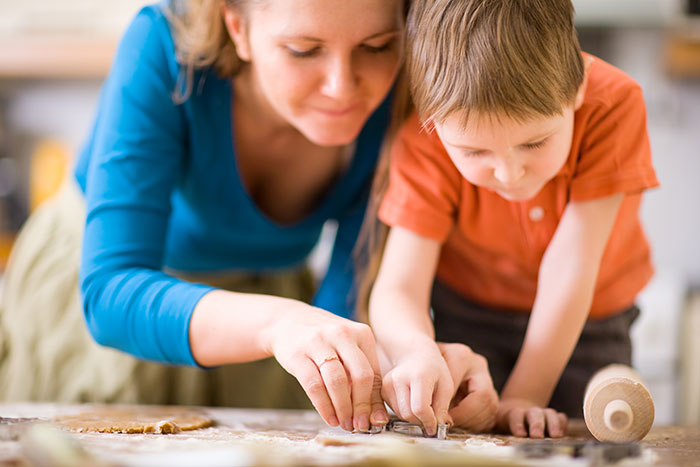 A mom and her son baking cookies
