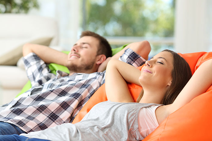 A mom and dad relax in their new living room after a long move