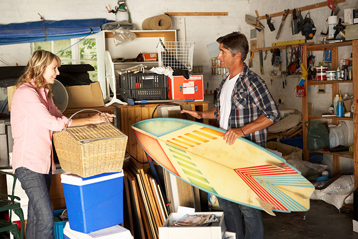 A man and woman working at clearing out their garage