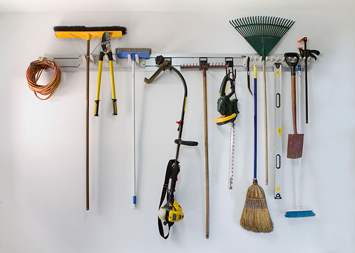 A board with garden tools hanging in a garage