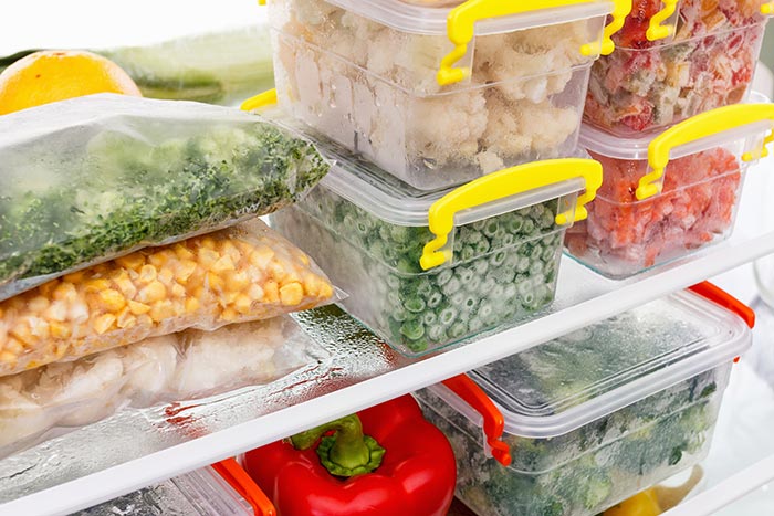 Plastic food storage containers in the freezer ready to be labeled for storage