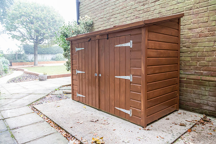 Wooden outdoor storage shed with multiple doors