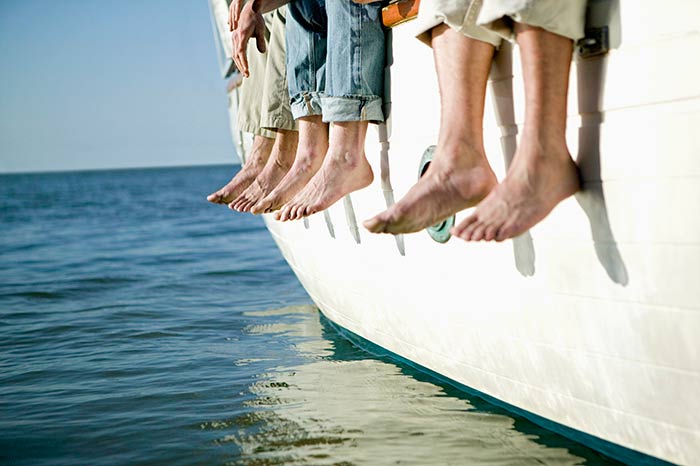 Feet dangeling off the side of a boat