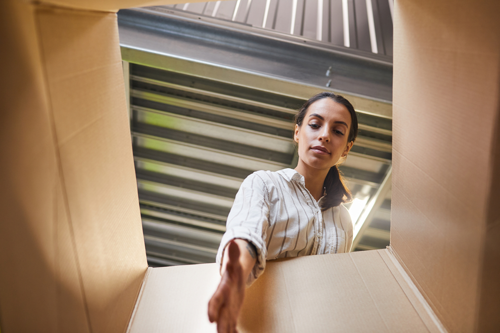 woman looking into box