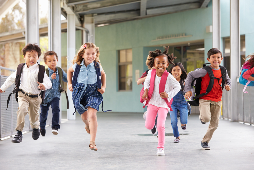 group of kids running outside school