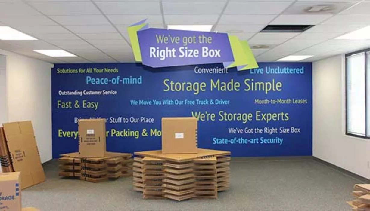 Moving box display with blue wall and graphics background