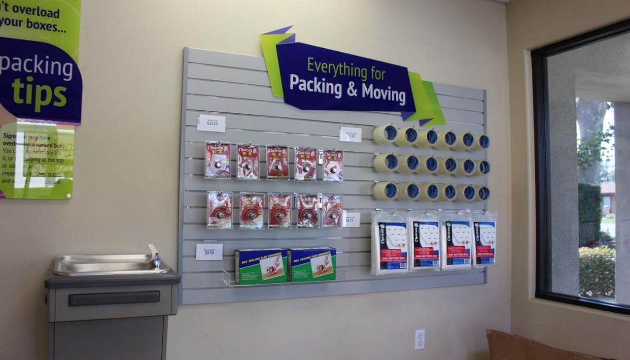 Rental office merchandise display wall with tape, bubble wrap, mattress bags for sale