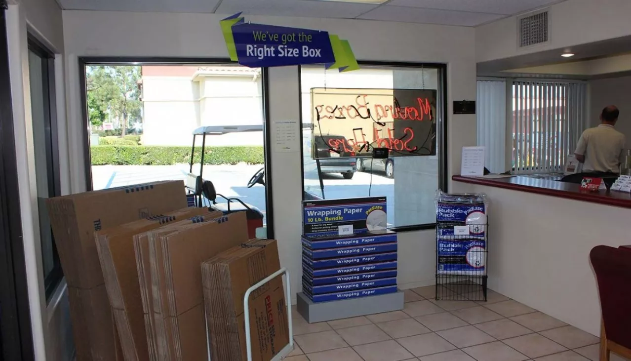 Rental office merchandise display wall with tape, bubble wrap, mattress bags for sale