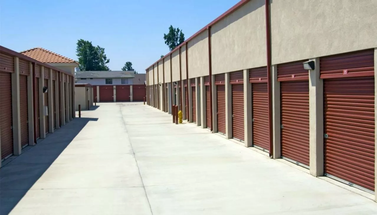 Wide drive aisle to large drive up storage units with roll up doors left, right and center