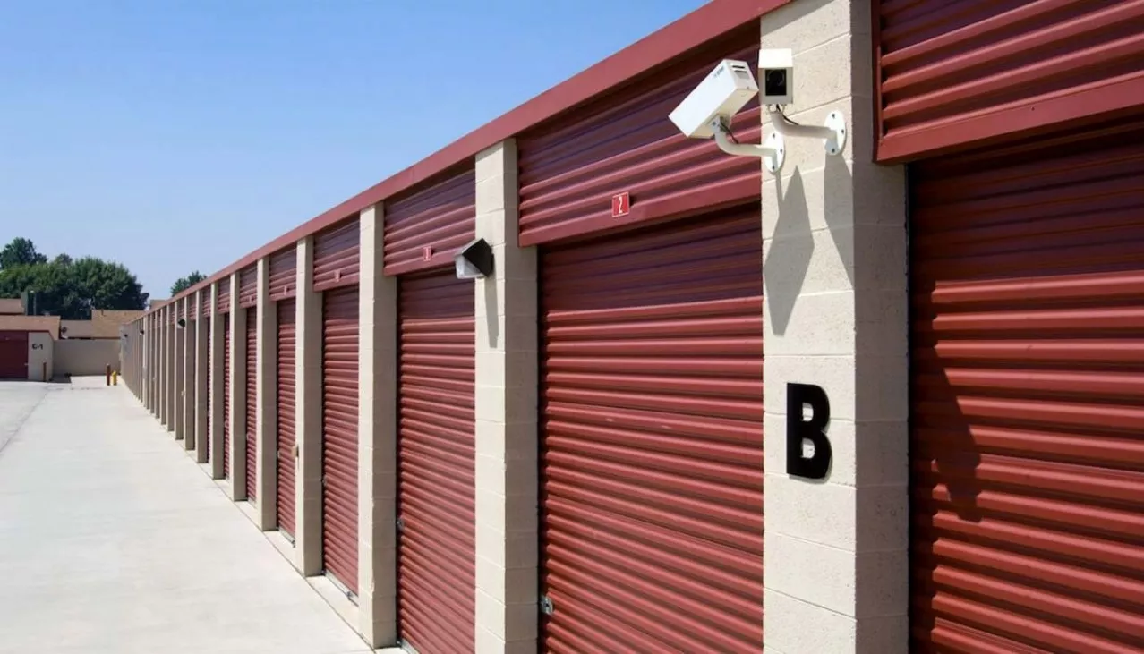Extra large drive up storage units with roll up doors and security camera on the building