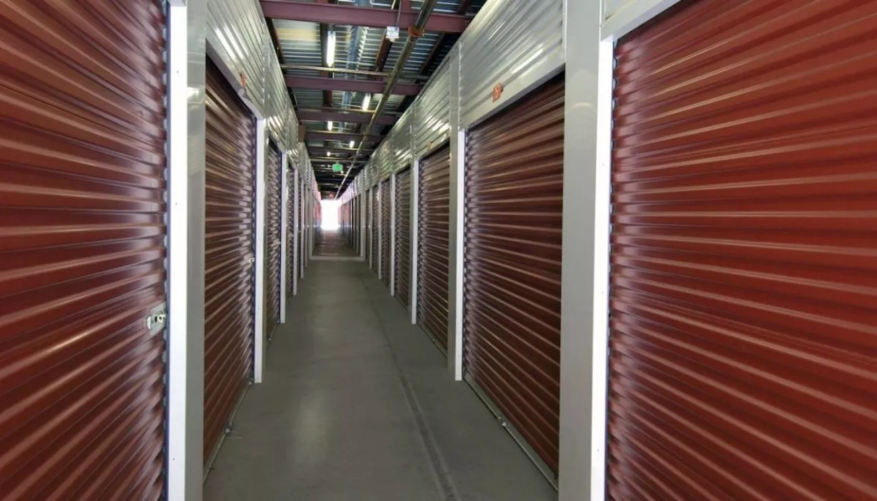 Hallway to ground floor accessible storage units with roll up doors