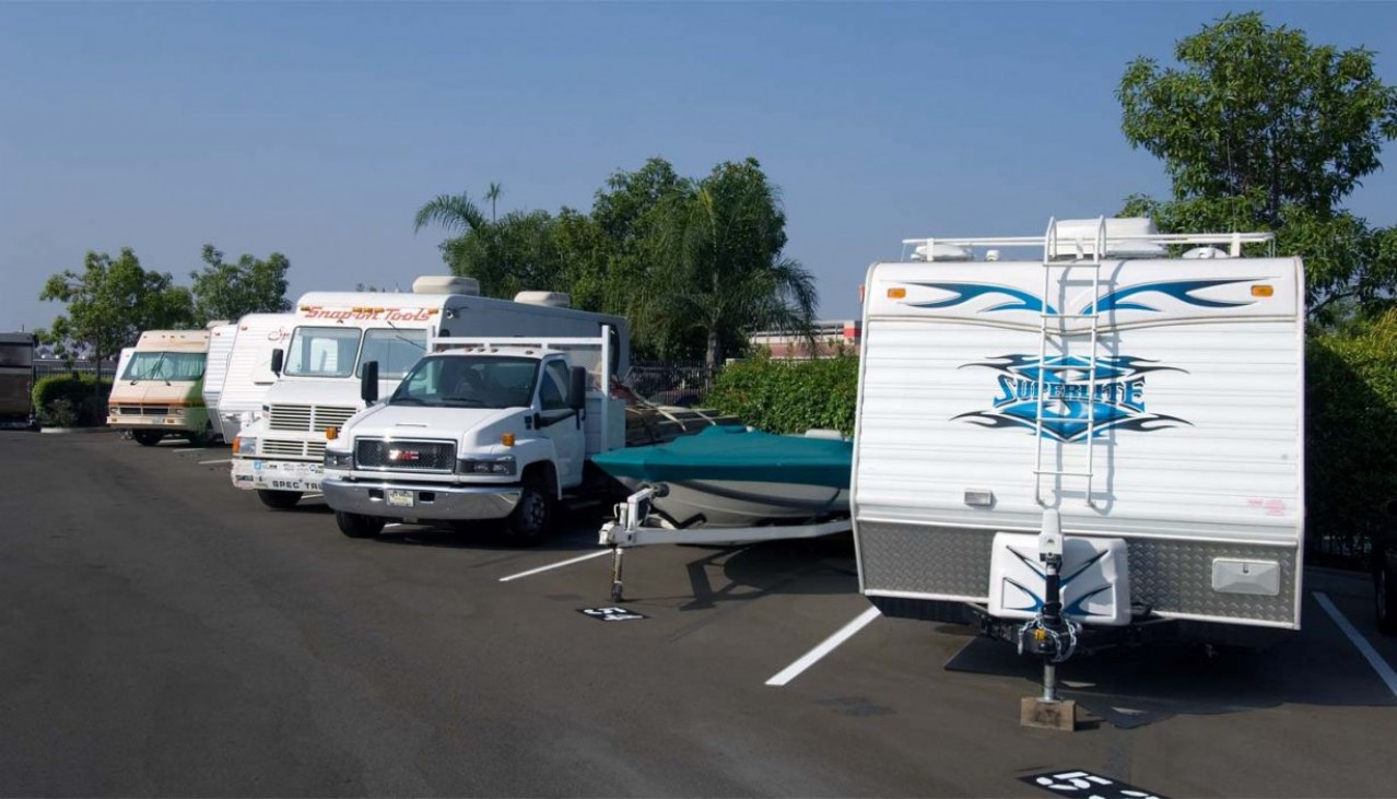 Cars, trucks, boats, RVs and trailers parked in outdoor storage spaces