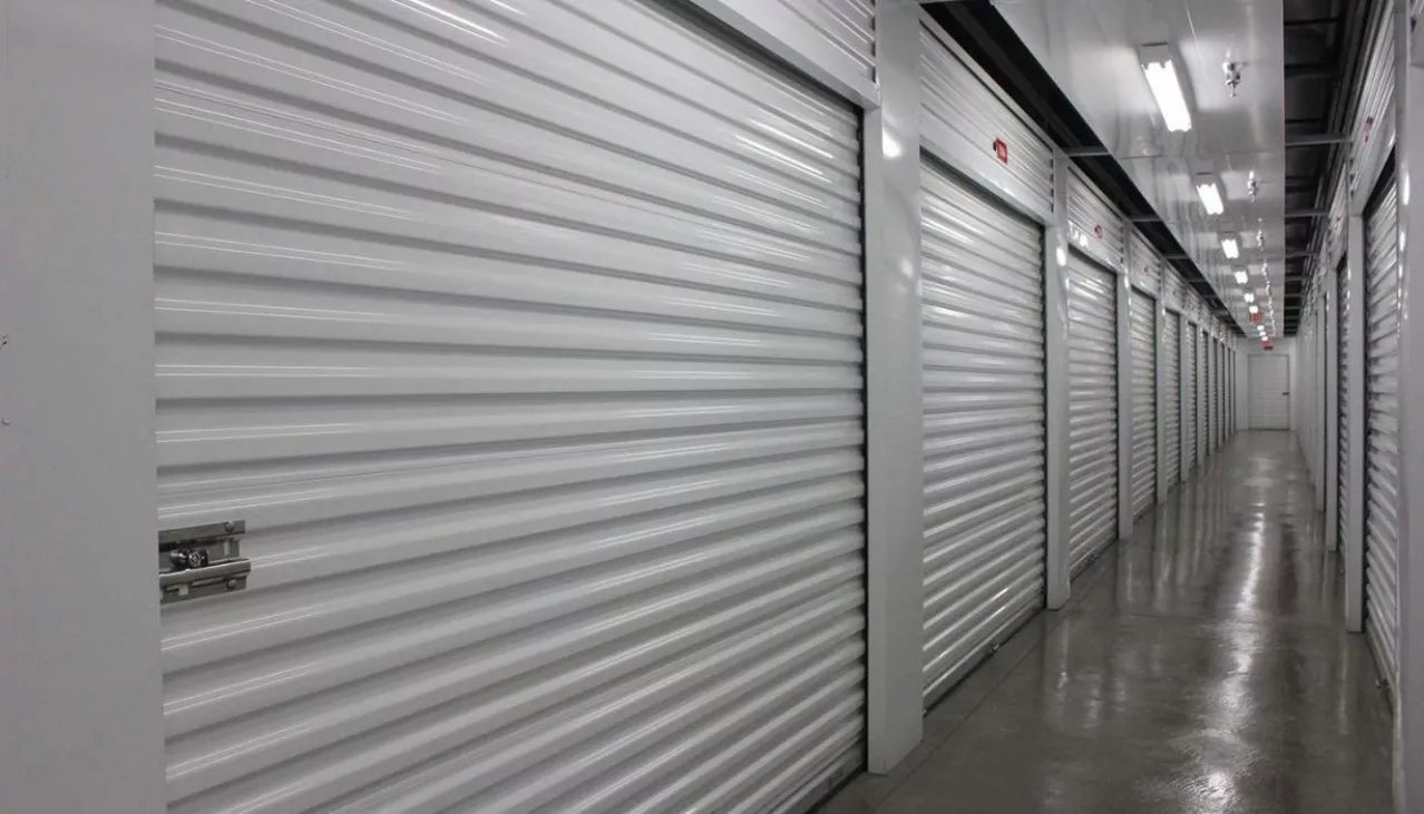 Interior hallway with large storage units with roll up doors left and right