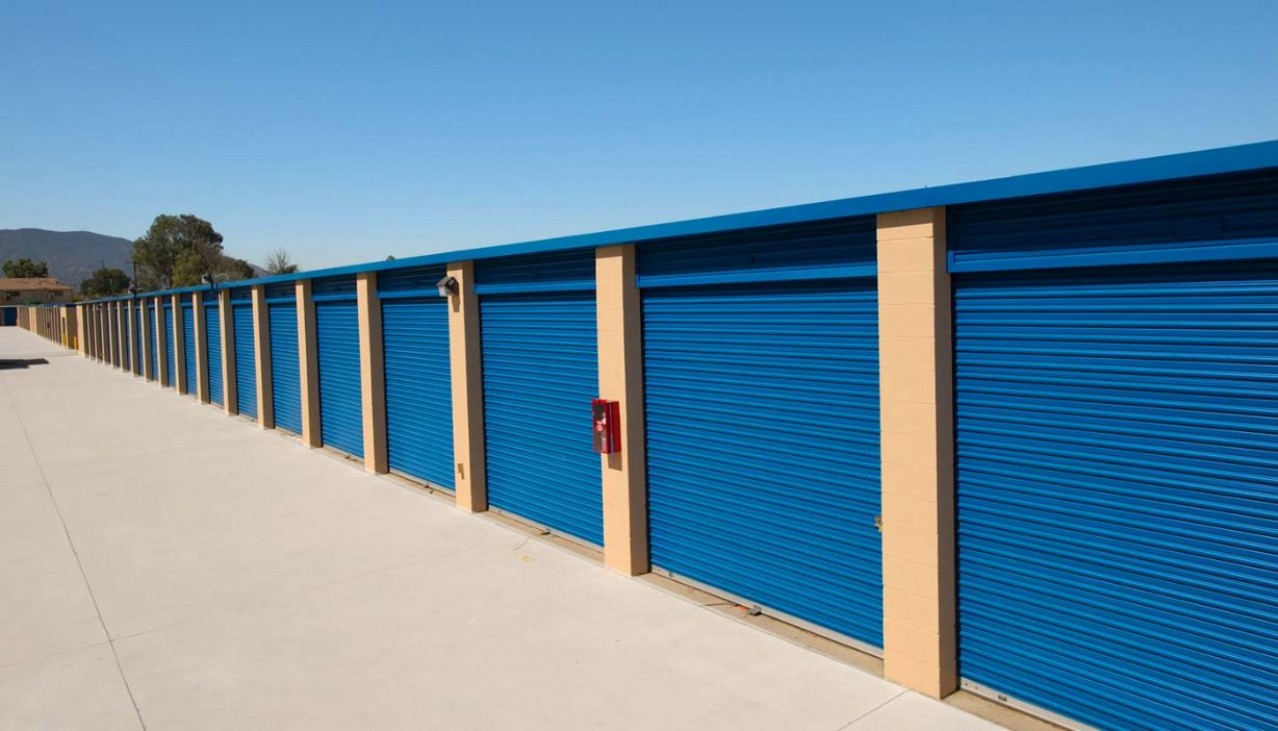 Drive up storage units with blue metal roll up doors
