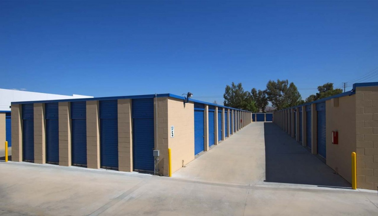 Drive up storage units with blue metal roll up doors