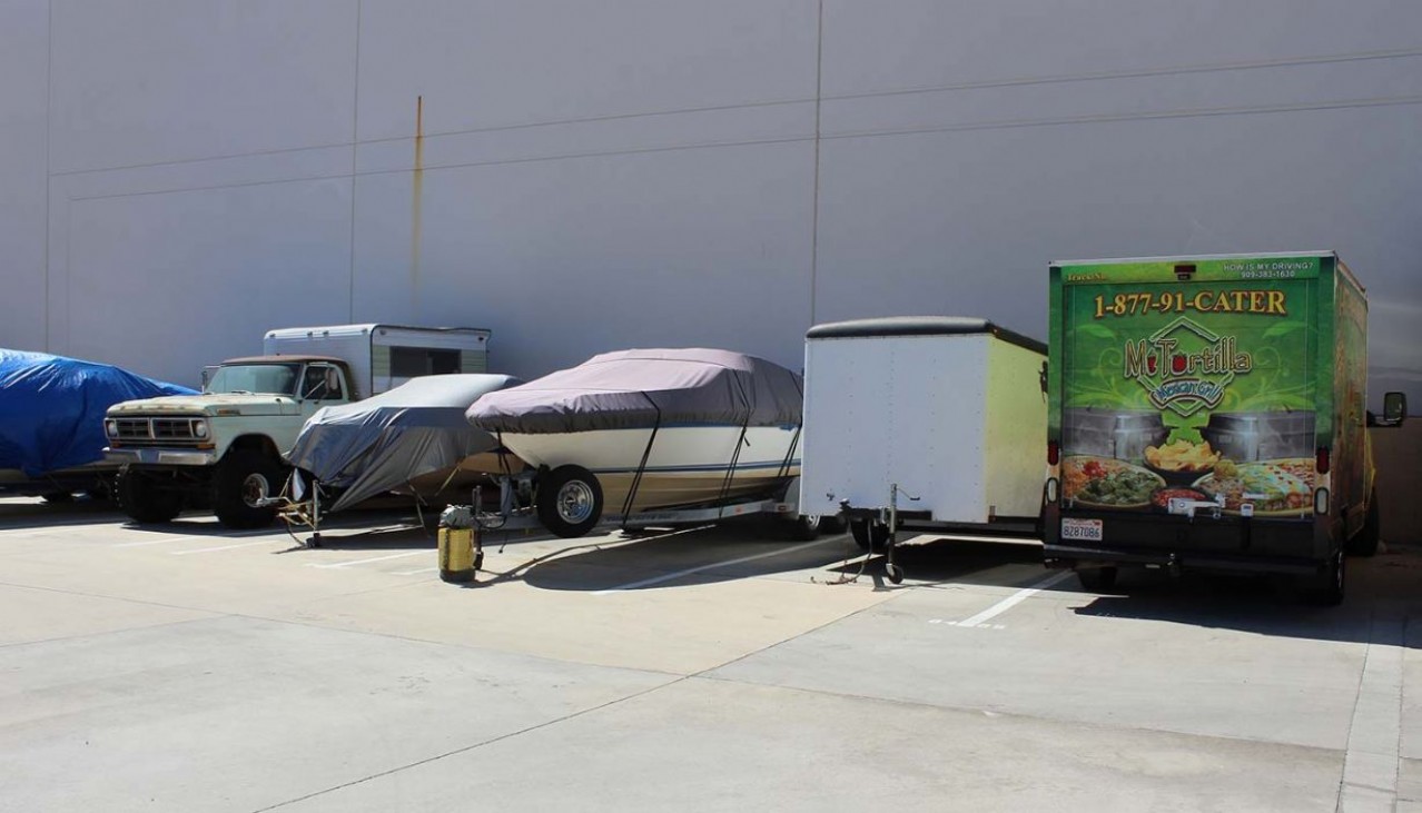 Trucks and trailers parked in vehicle storage spaces