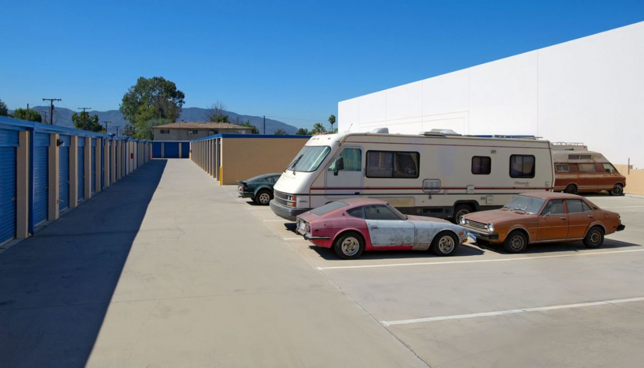 Cars and a large RV parked in vehicle storage spaces