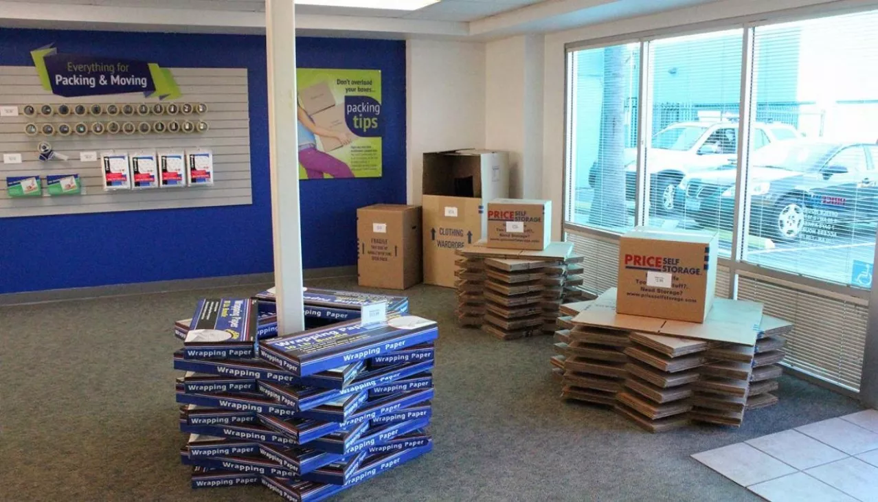Price Self Storage Pacific Beach rental office with wrapping paper and moving box displays stacked