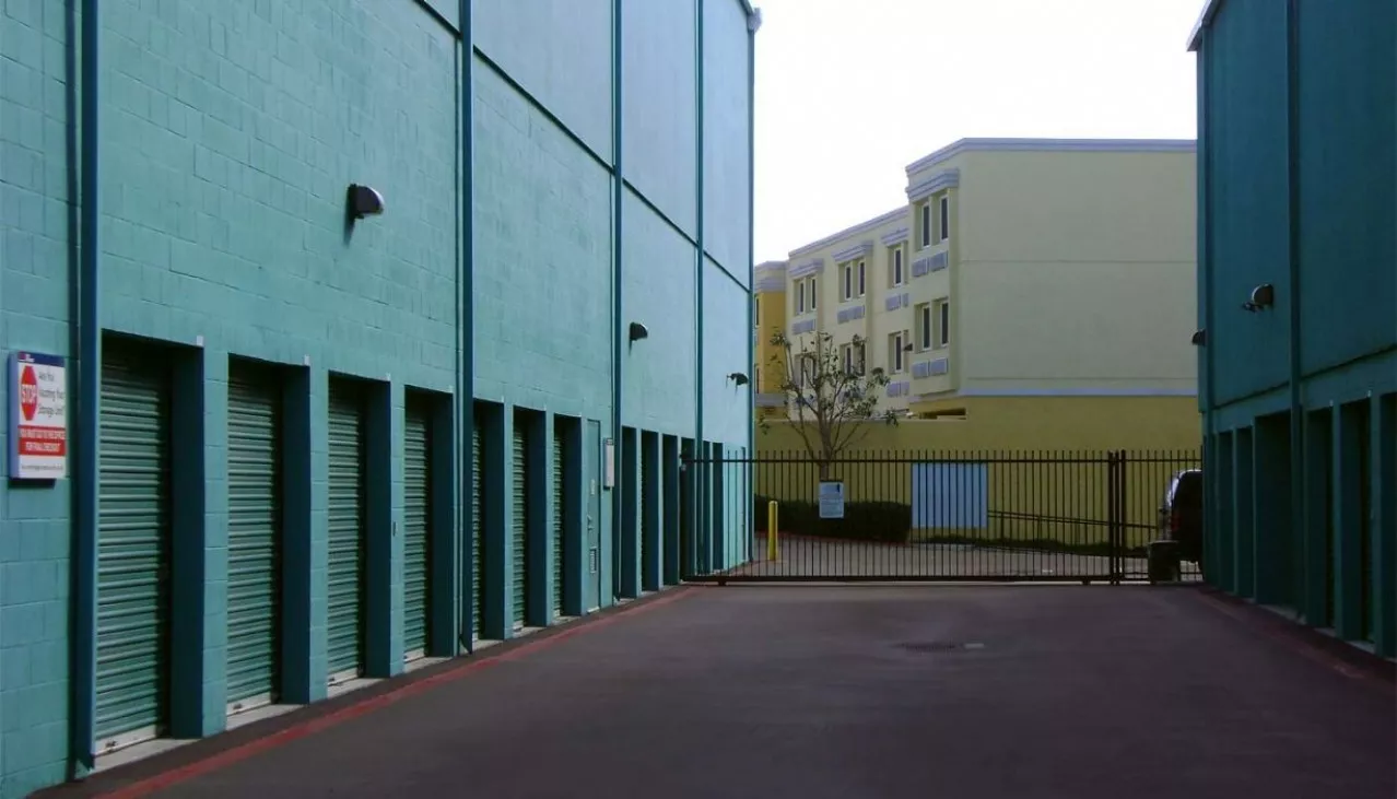 Price Self Storage Pacific Beach drive up access units with roll up doors on either side of the computerized access gate