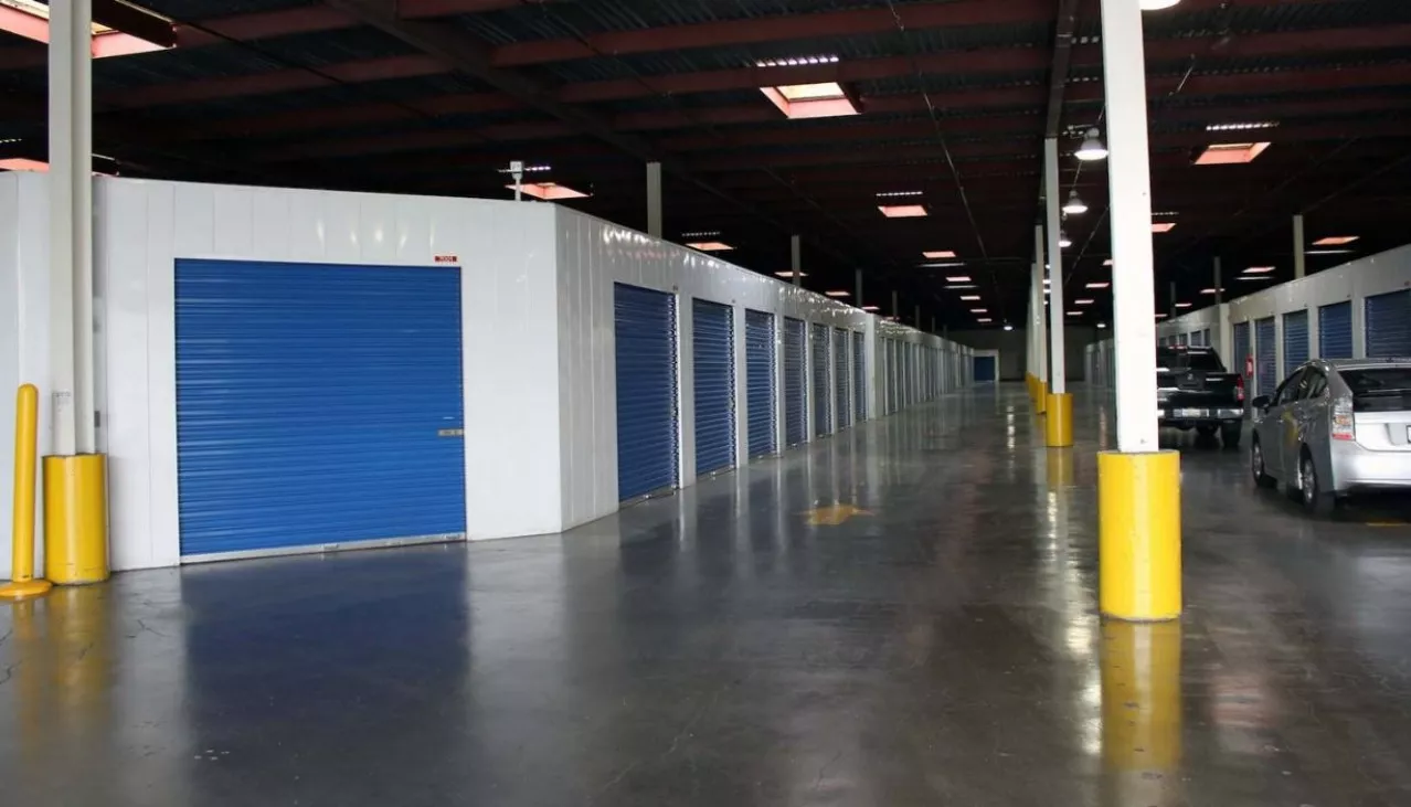 Indoor drive-in storage facility with rollup doors