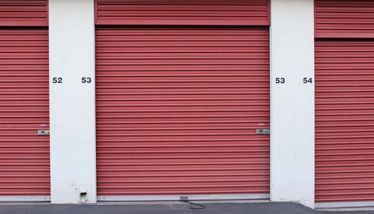 Storage facility interior hallway with rollup doors