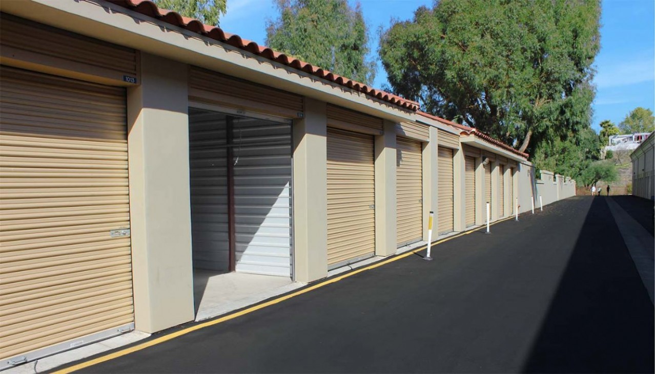 Large drive up storage unit with concrete block and metal interior walls and roll up doors